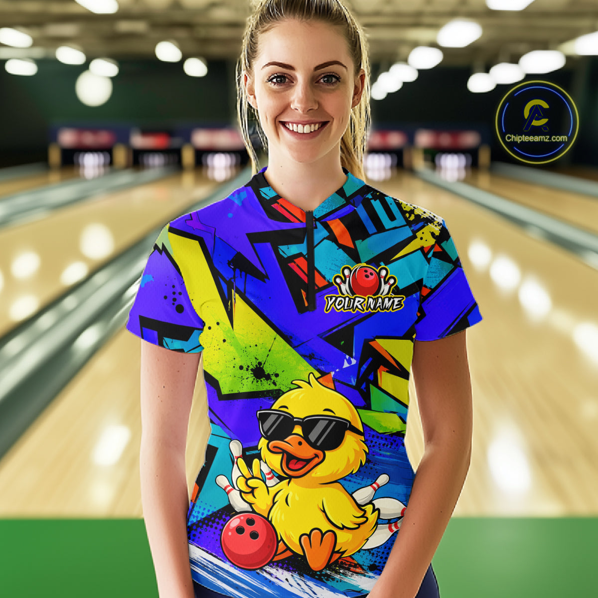 Person wearing a colorful bowling shirt with a duck graphic in a bowling alley.