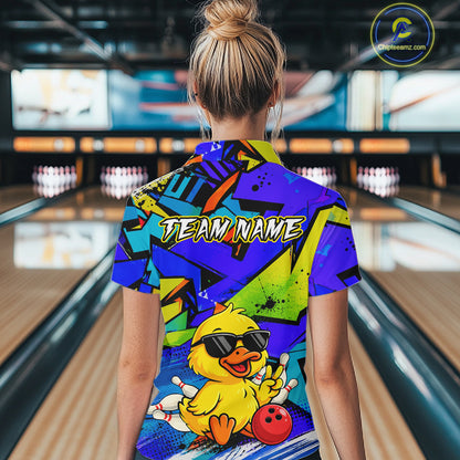 Person wearing a colorful bowling shirt with a duck graphic in a bowling alley.