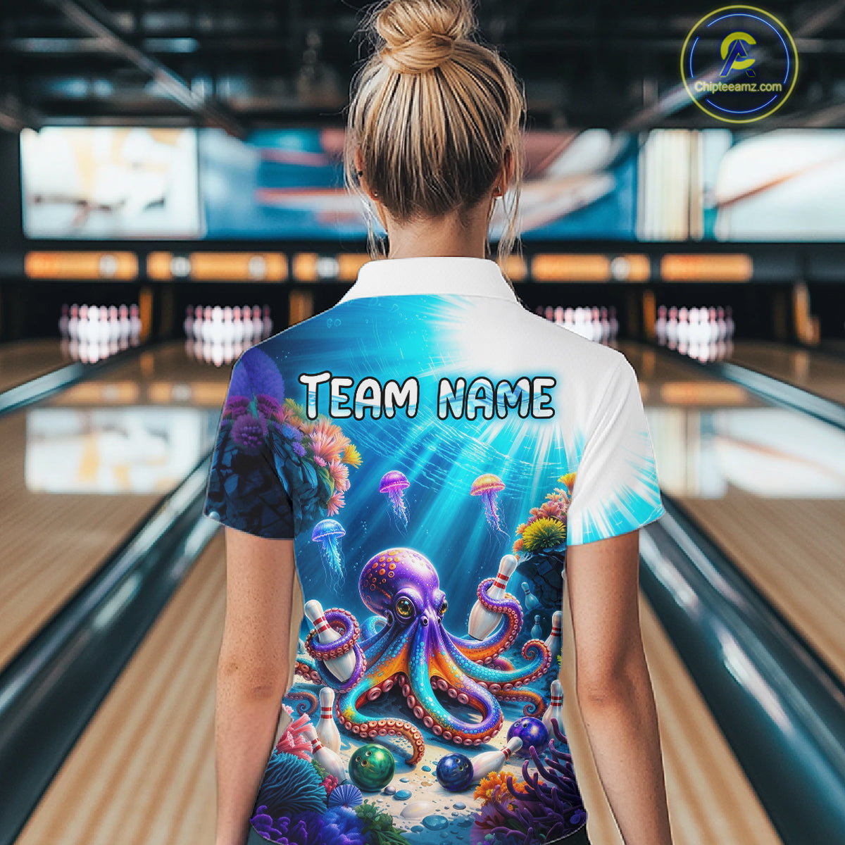 Woman wearing a colorful bowling shirt with an octopus design and 'Team Name' text in a bowling alley.