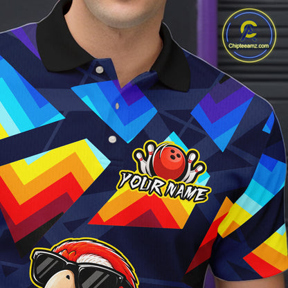 A close-up of a person wearing a short-sleeve polo shirt with a colorful geometric pattern in blue, yellow, red, and orange on a dark navy base. The shirt has a black collar, white buttons, a bowling ball graphic with pins, and the text 'YOUR NAME' on the chest.