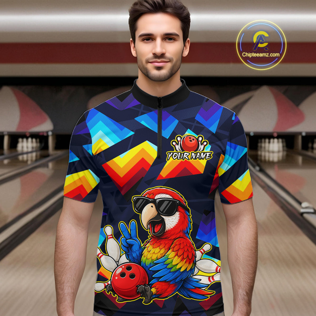 A man wearing a short-sleeve bowling jersey with a colorful geometric pattern and a cartoon parrot graphic, standing in front of a blurred bowling alley background. The jersey has a black collar and a black front zipper, with a 'YOURNAME' placeholder on the chest.