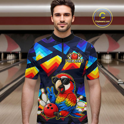 A man wearing a short-sleeve bowling jersey with a colorful geometric pattern and a cartoon parrot graphic, standing in front of a blurred bowling alley background. The jersey has a black collar and a black front zipper, with a 'YOURNAME' placeholder on the chest.