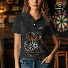 Load image into Gallery viewer, Women wearing darts polo shirt featuring a cobra wrapped around a dartboard with cobra snake artwork on a black background.