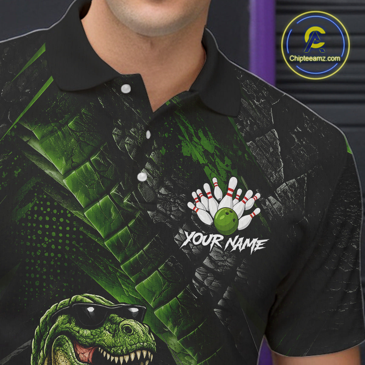 Bowling polo shirt featuring a dinosaur standing among bowling pins and ball artwork on black green textured background.