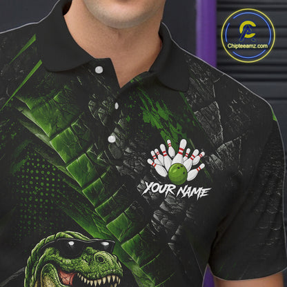 Bowling polo shirt featuring a dinosaur standing among bowling pins and ball artwork on black green textured background.