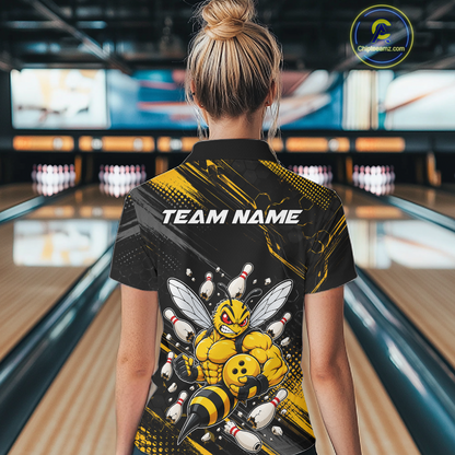 Women wearing bowling polo shirt featuring a muscular bee holding a bowling ball surrounded by pins on black yellow background.