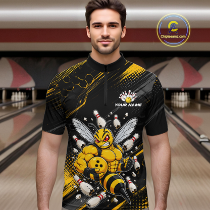 Man wearing bowling quarter zip shirt featuring a muscular bee holding a bowling ball surrounded by pins on black yellow background.