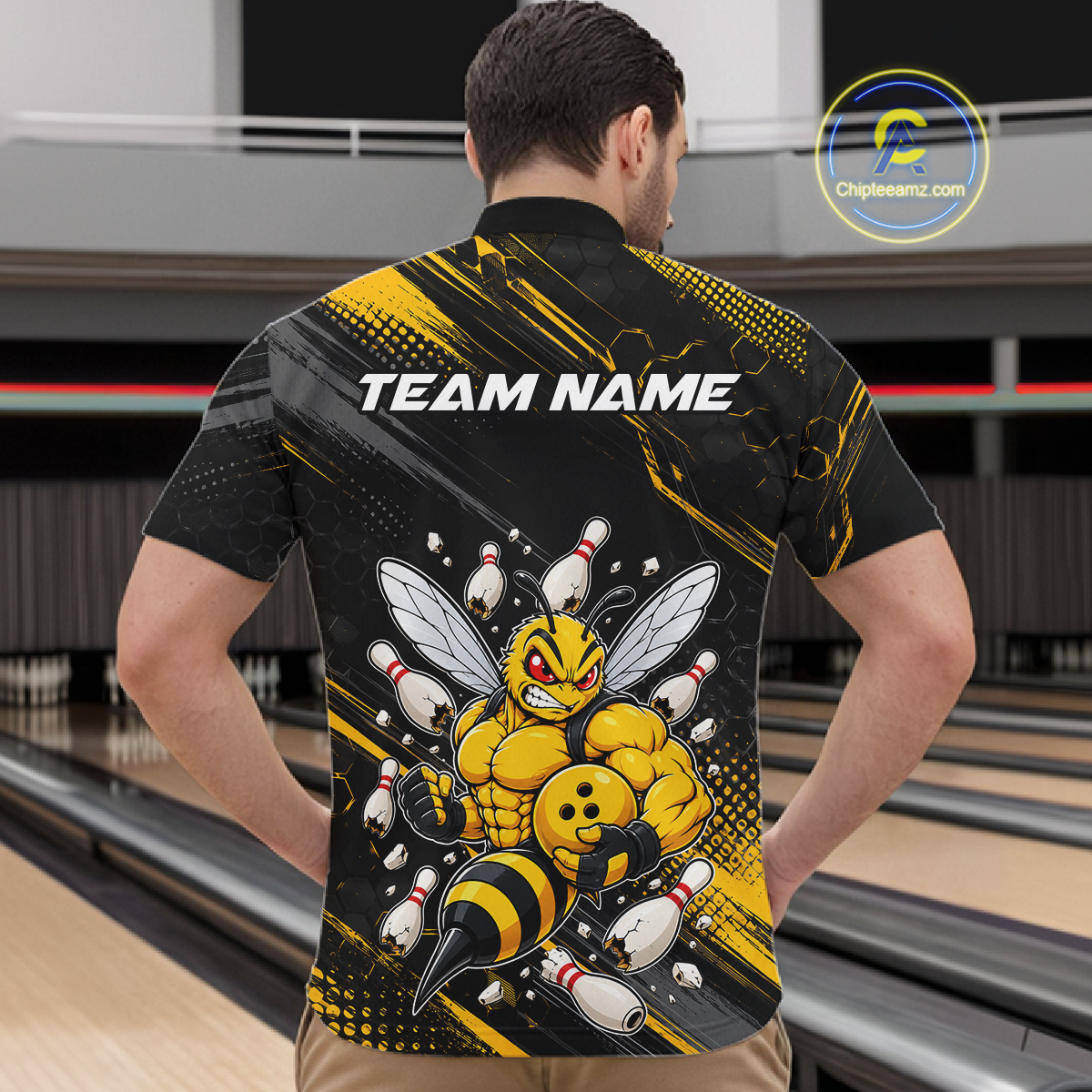 Man wearing bowling quarter zip shirt featuring a muscular bee holding a bowling ball surrounded by pins on black yellow background.