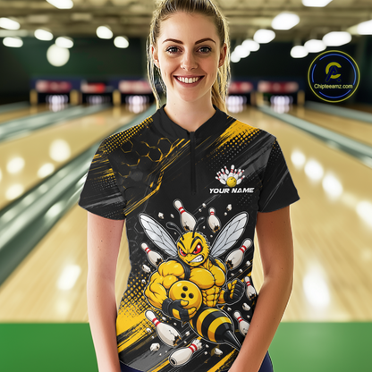 Women wearing bowling quarter zip shirt featuring a muscular bee holding a bowling ball surrounded by pins on black yellow background.