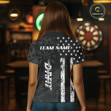 Load image into Gallery viewer, Women wearing darts polo shirt featuring dartboard patterns layered with american flag graphics and geometric details on a black background.