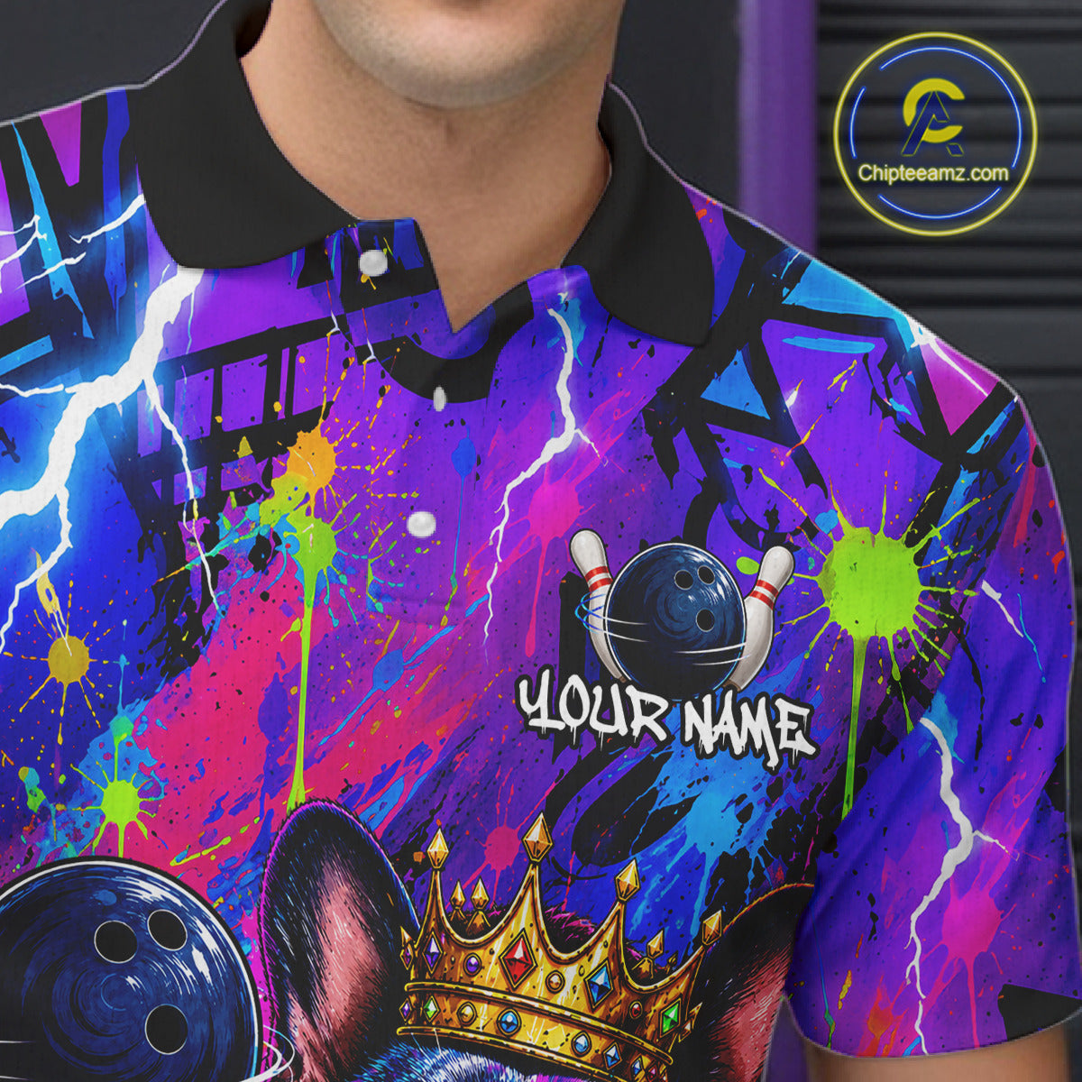 Personalized bowling polo shirt with a crowned bulldog holding a bowling ball, surrounded by paint effects and bold graphic patterns.