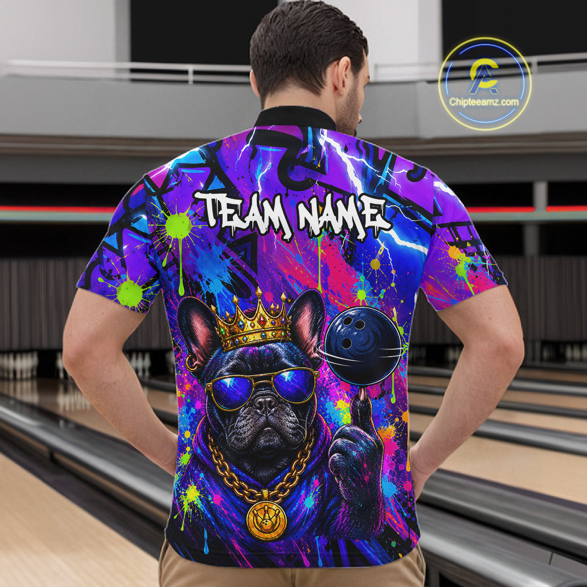 Men wearing personalized bowling quarter zip shirt with a crowned bulldog holding a bowling ball, surrounded by paint effects and bold graphic patterns.