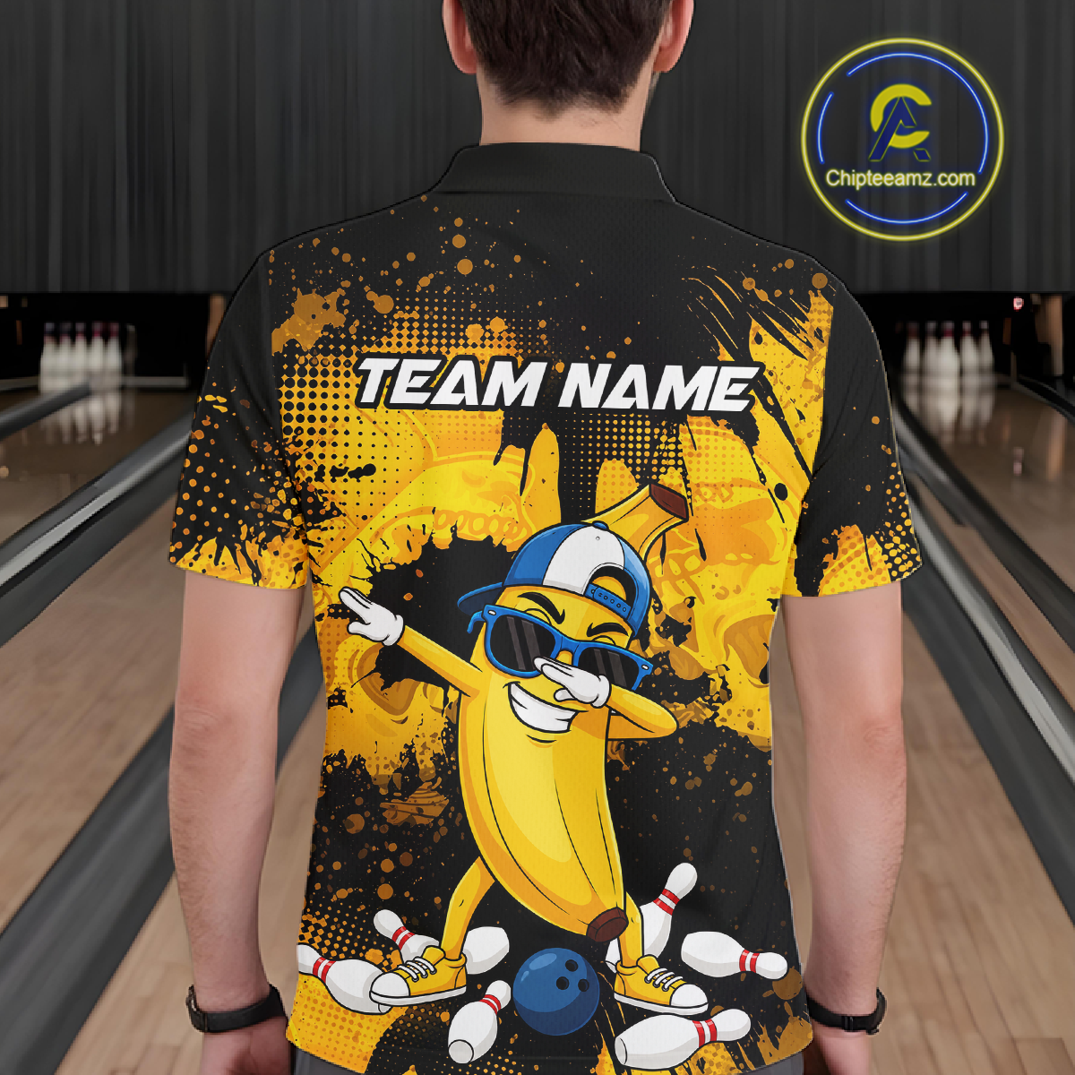 Man wearing a black and yellow bowling polo featuring a cool banana mascot dabbing, bowling pins, a blue bowling ball, and custom team text.