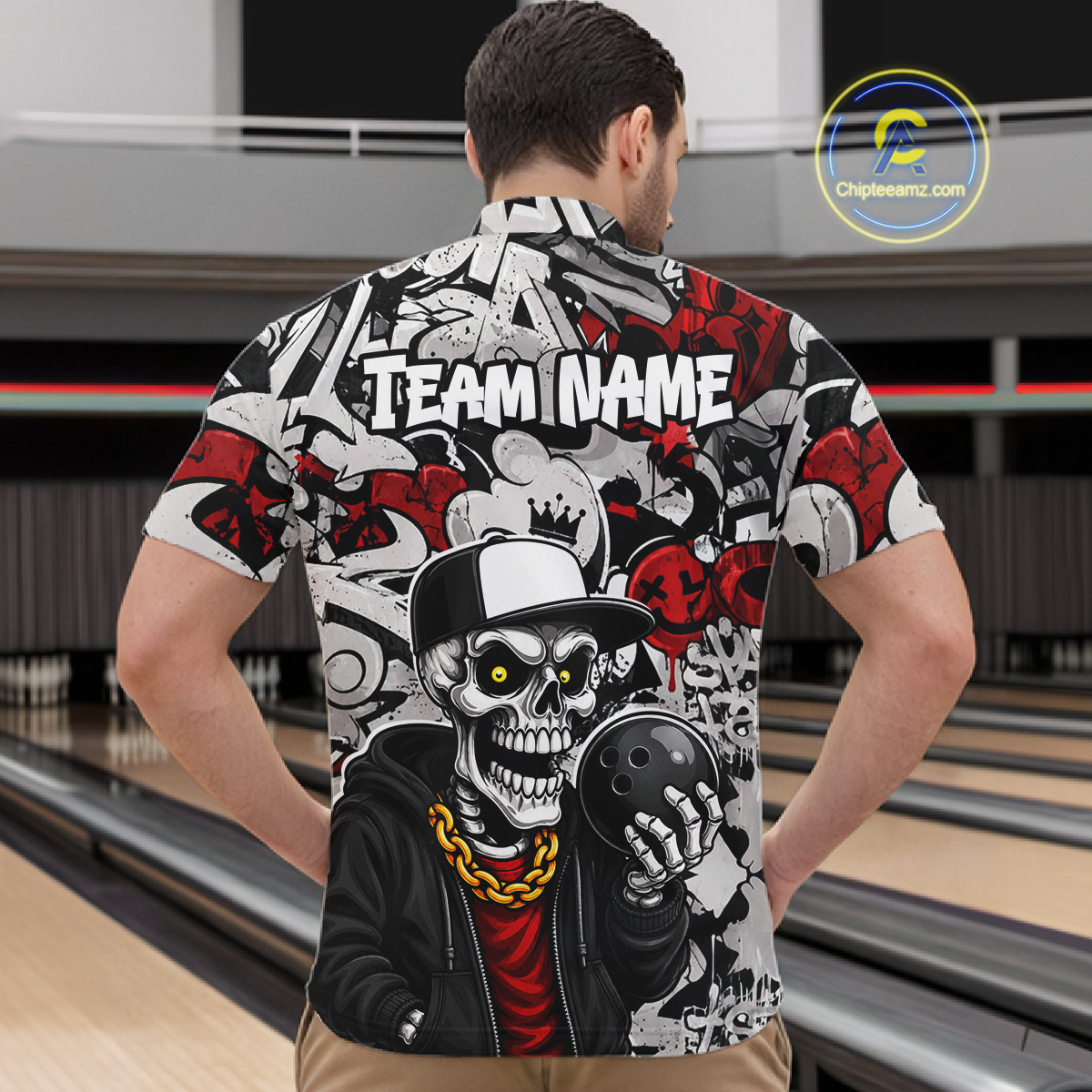 Man wearing a bowling-themed shirt with a skeleton holding a bowling ball in a bowling alley.