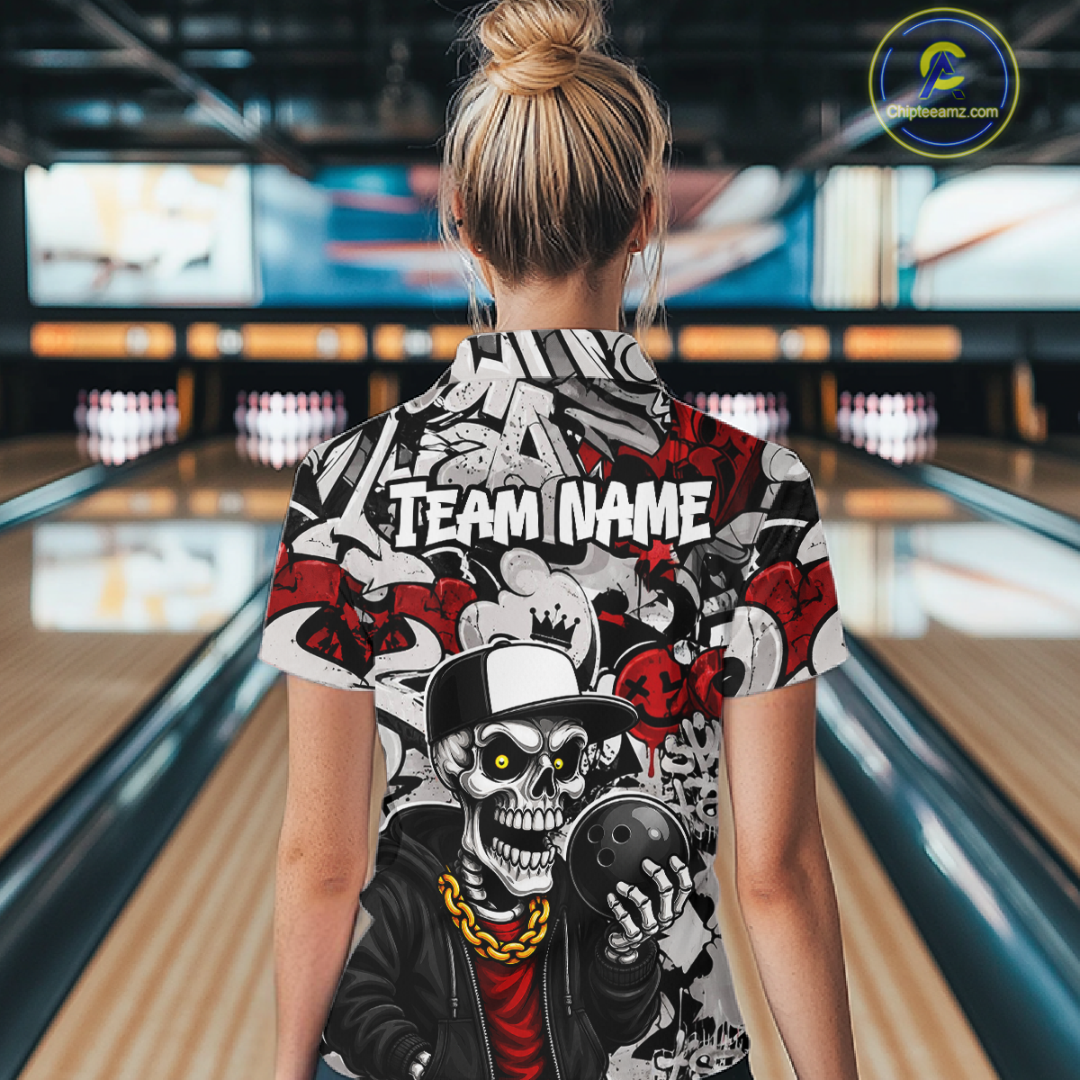 Person wearing a colorful bowling shirt with a skull design in a bowling alley.