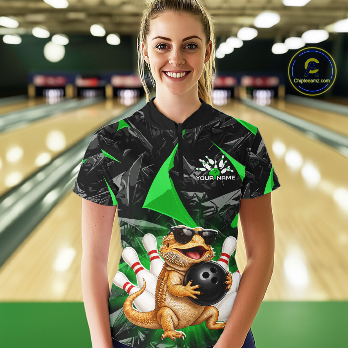 Women’s green bearded dragon bowling quarter zip shirt, front view on female model in bowling lane 