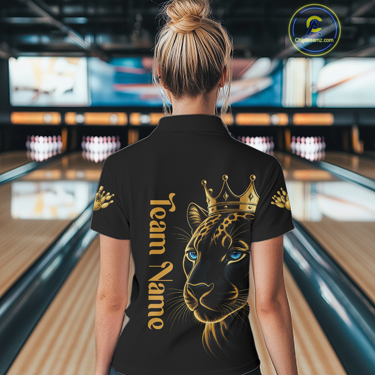 Person wearing a black shirt with a leopard design and 'Team Name' text in a bowling alley.