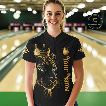 Woman wearing a black shirt with a gold panther design and 'Your Name' text in a bowling alley.