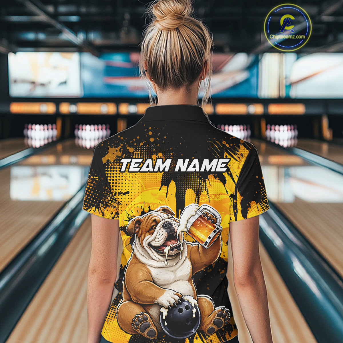 Person wearing a shirt with a bulldog graphic and 'Team Name' text in a bowling alley.