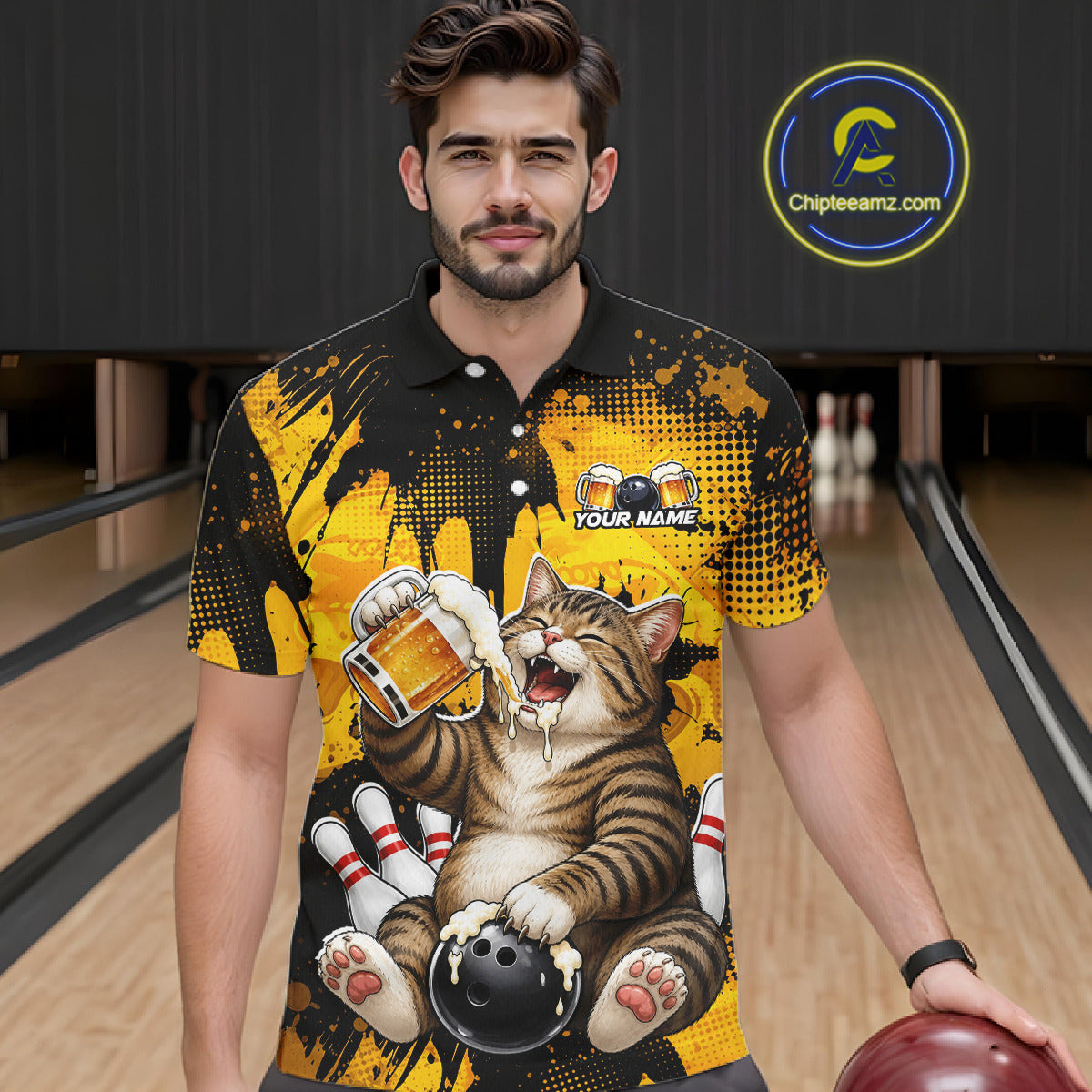 Man wearing a black and yellow bowling-themed shirt with a cat design in a bowling alley.