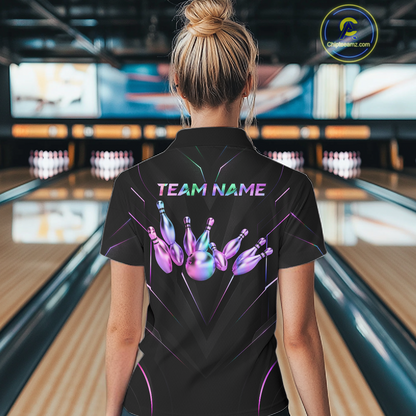 Person wearing a black bowling shirt with gold designs and 'TEAM NAME' text in a bowling alley.