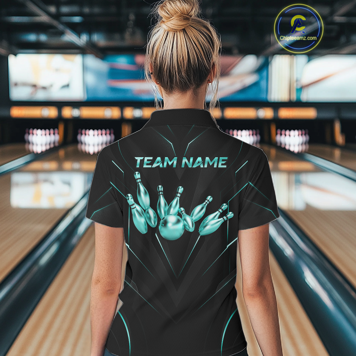 Person wearing a black bowling shirt with 'TEAM NAME' and bowling pin design in a bowling alley.