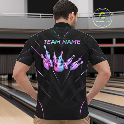 Person wearing a black bowling shirt with colorful design and 'TEAM NAME' text at a bowling alley.