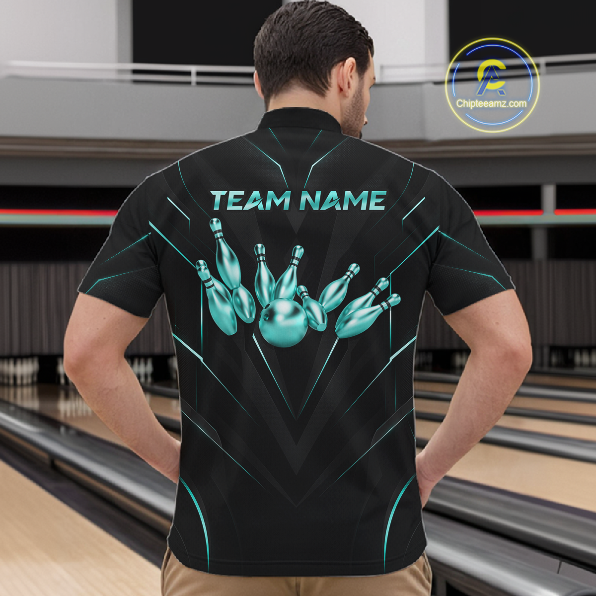 Person wearing a black bowling shirt with teal graphics and 'TEAM NAME' text at a bowling alley.