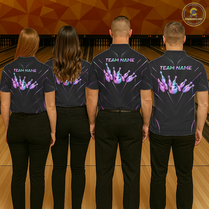 Four people wearing black shirts with colorful designs and 'TEAM NAME' text on a bowling alley.
