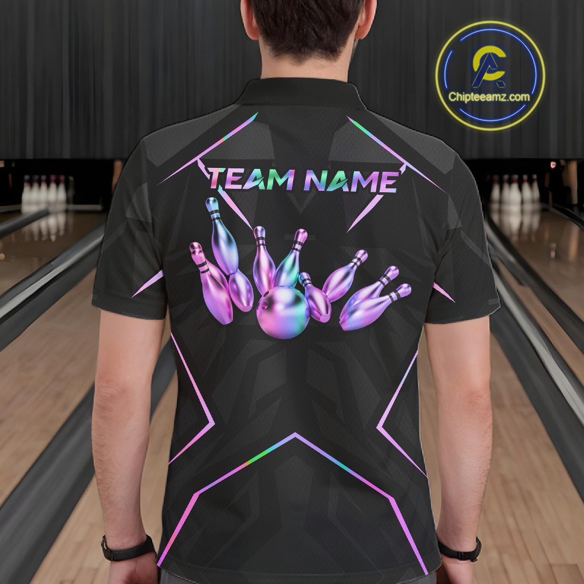 Person wearing a black bowling shirt with colorful design and 'TEAM NAME' text in a bowling alley.