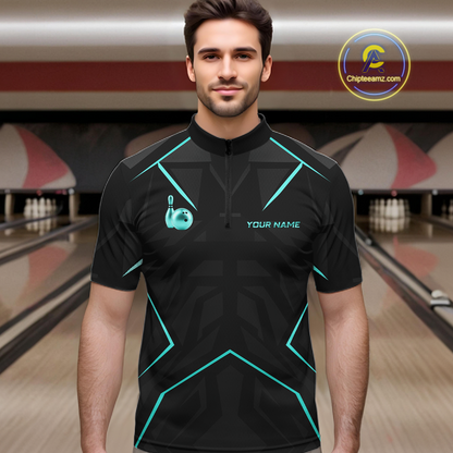 Man wearing a black bowling shirt with colorful designs in a bowling alley.