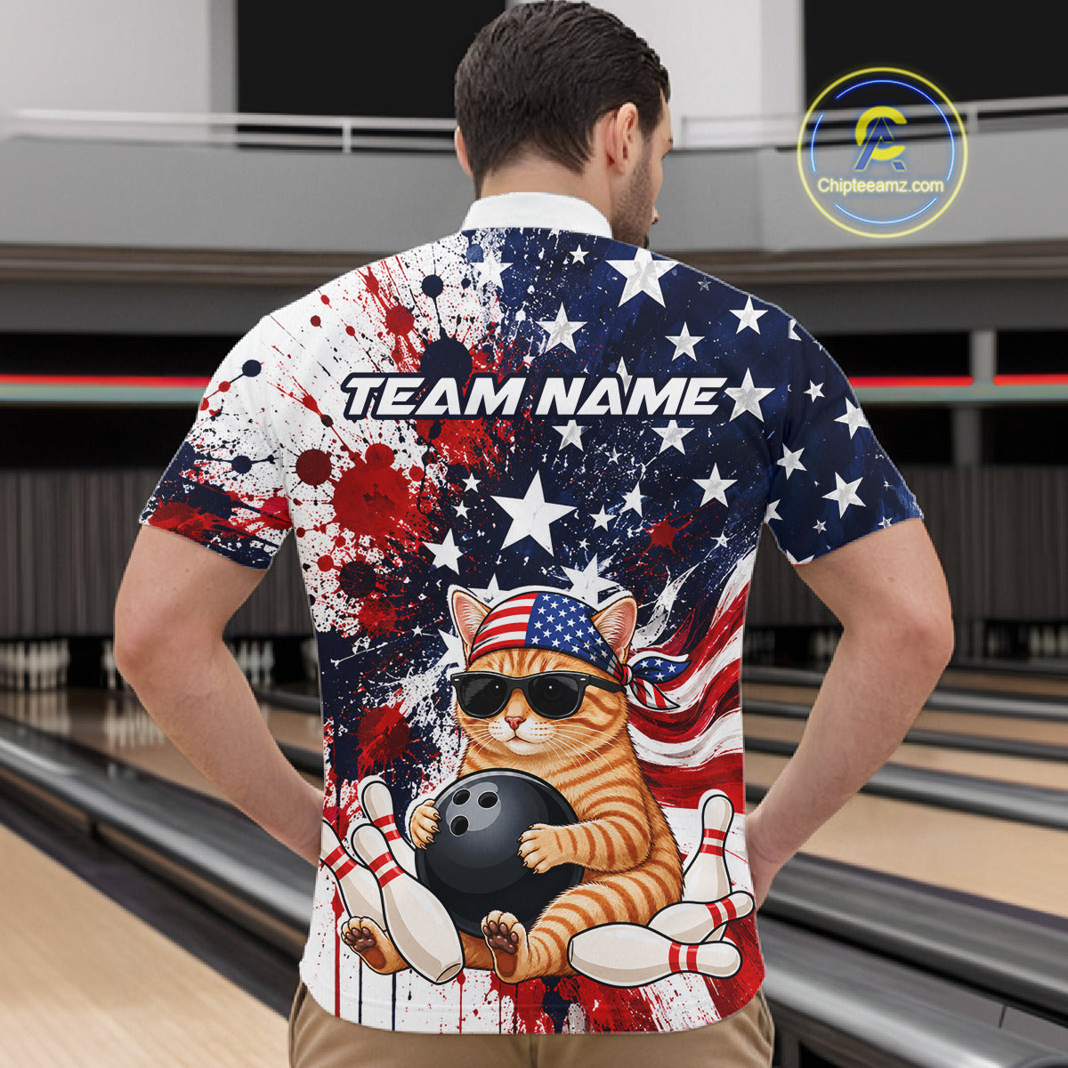 Person wearing a colorful shirt with a cat graphic and 'Team Name' text in a bowling alley.
