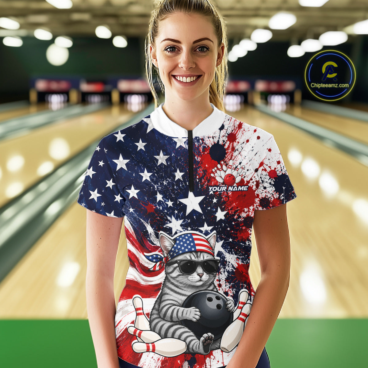 Woman wearing a colorful bowling shirt with a cat design in a bowling alley.