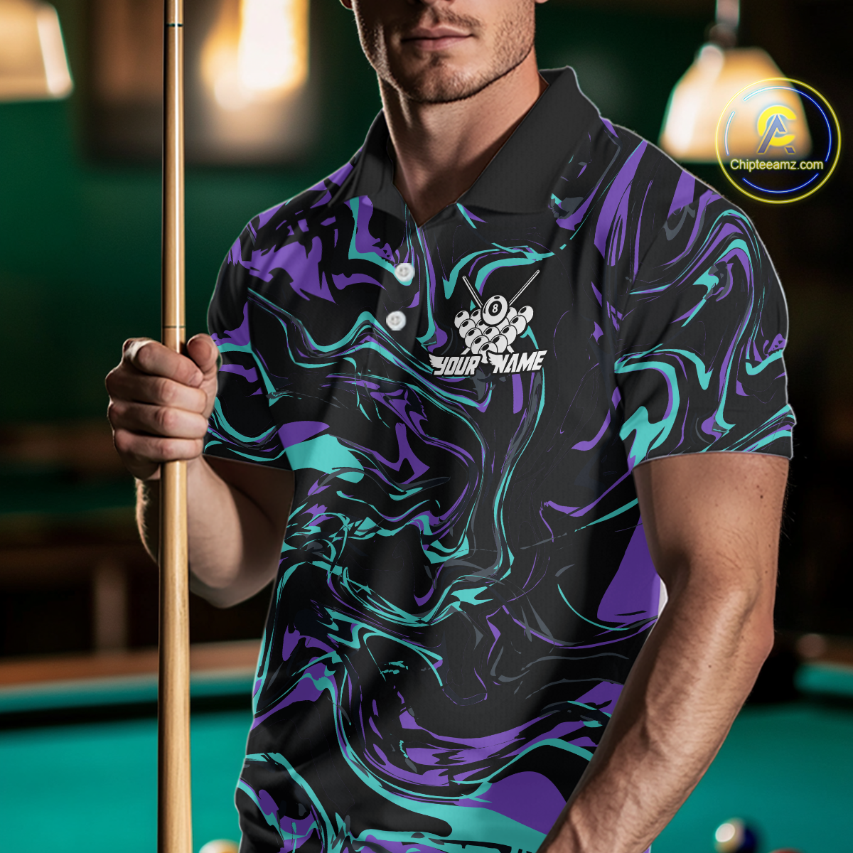 Man wearing a black billiards polo with teal and purple marble swirls, a custom chest name logo, and a pool table in the background.