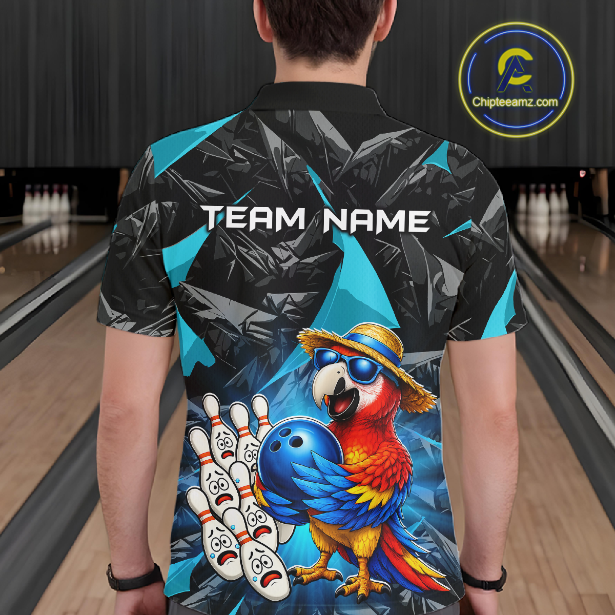 Person wearing a bowling-themed shirt with a parrot design in a bowling alley.