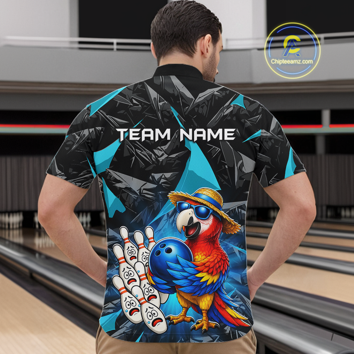 Man wearing a colorful bowling shirt with a parrot design in a bowling alley.