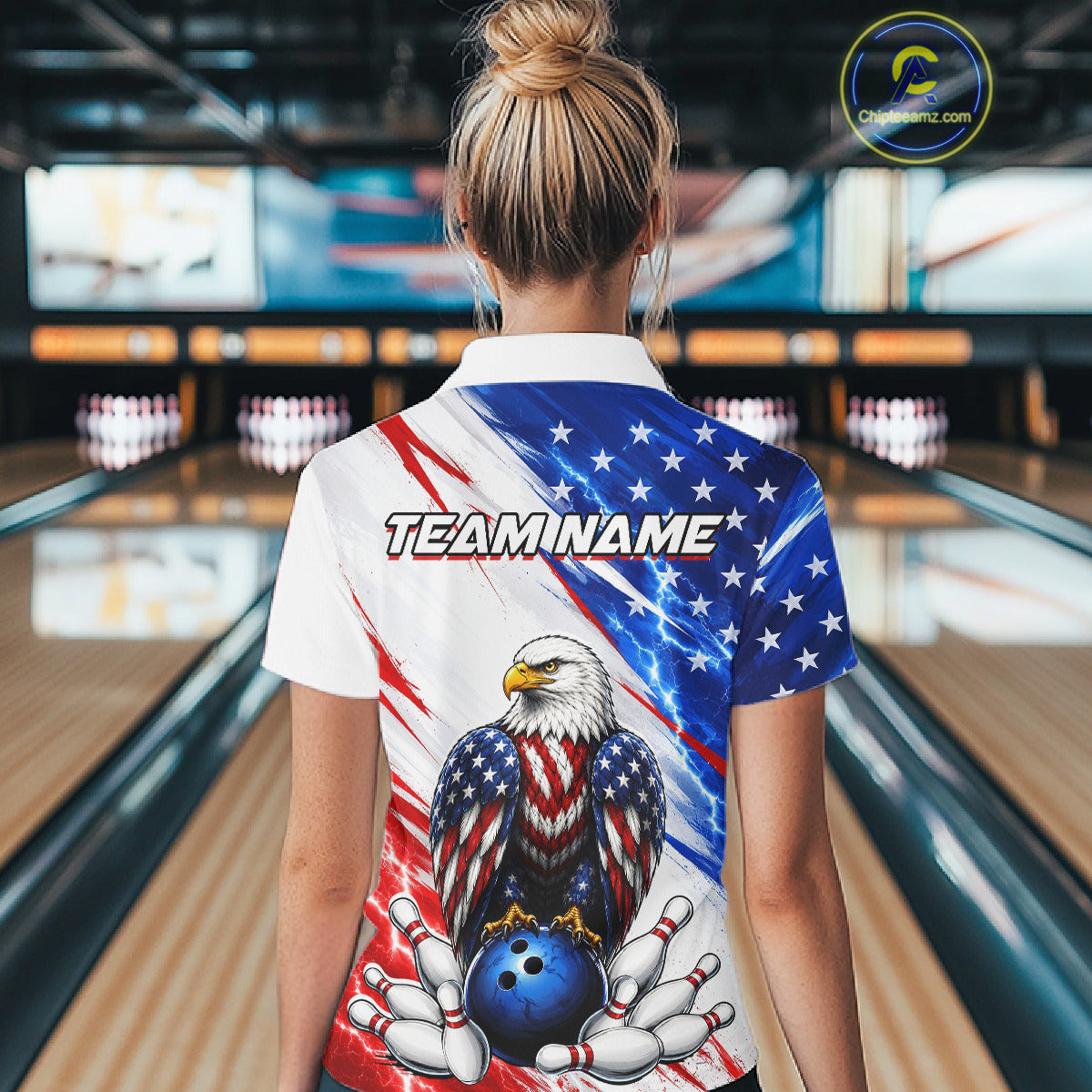 Person wearing a bowling shirt with American flag design and eagle in a bowling alley.