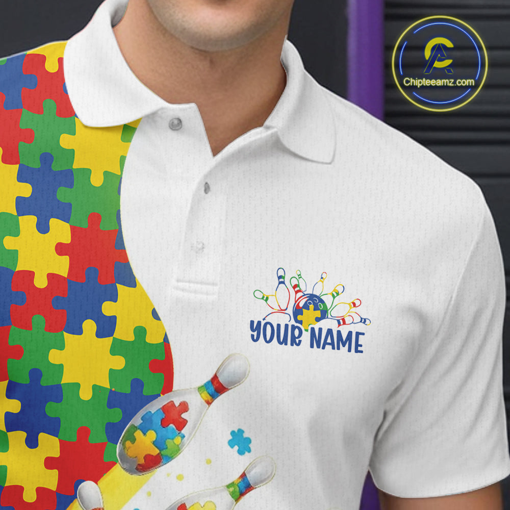 Close-up left chest detail of white bowling polo shirt featuring colorful autism bowling strike emblem with puzzle accents