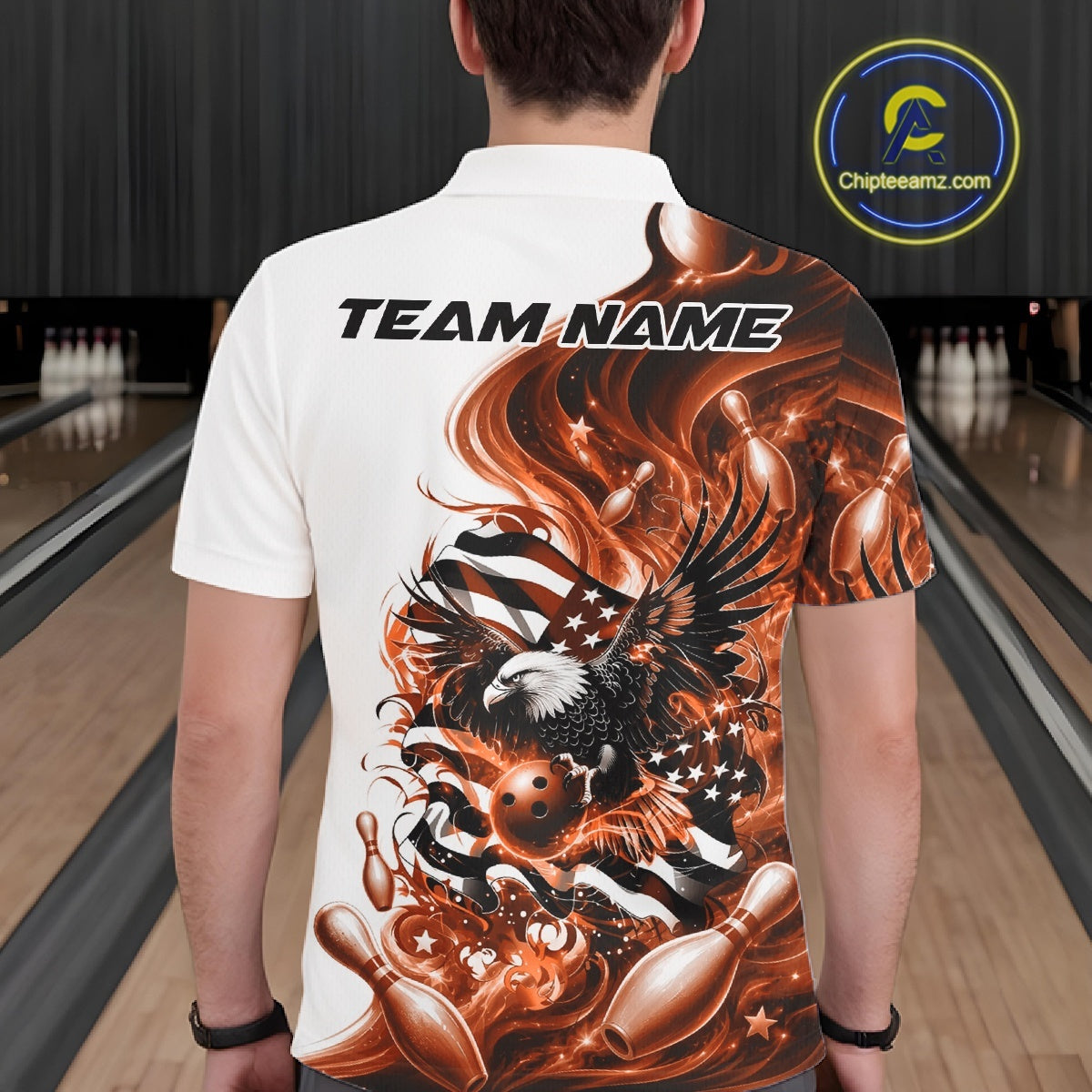 Back view of a male model in a bowling lane wearing a white and orange bowling polo shirt with eagle and flag inspired artwork.