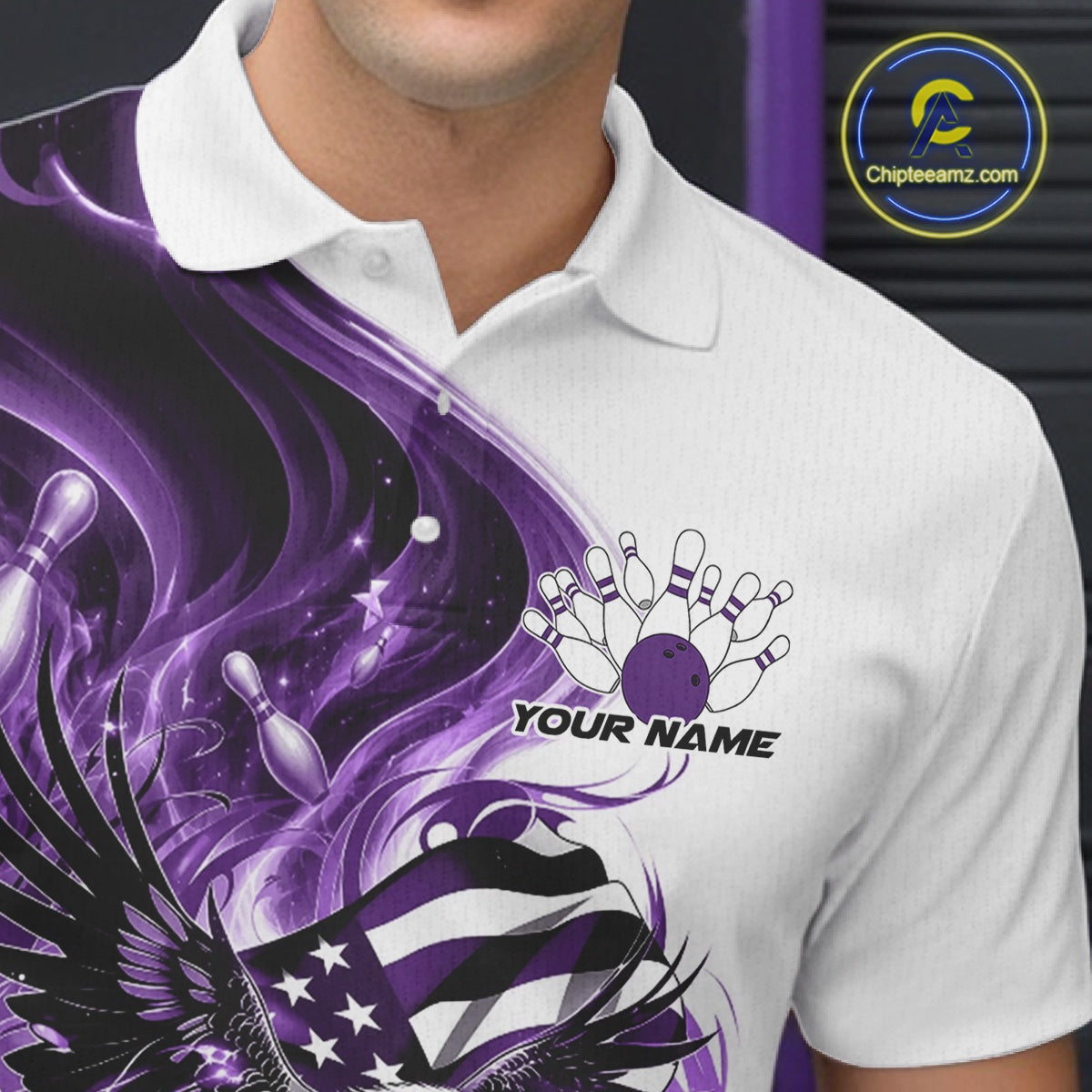 Close up left chest view of a white and purple bowling polo shirt with eagle artwork, bowling elements, and flowing flag inspired graphics.