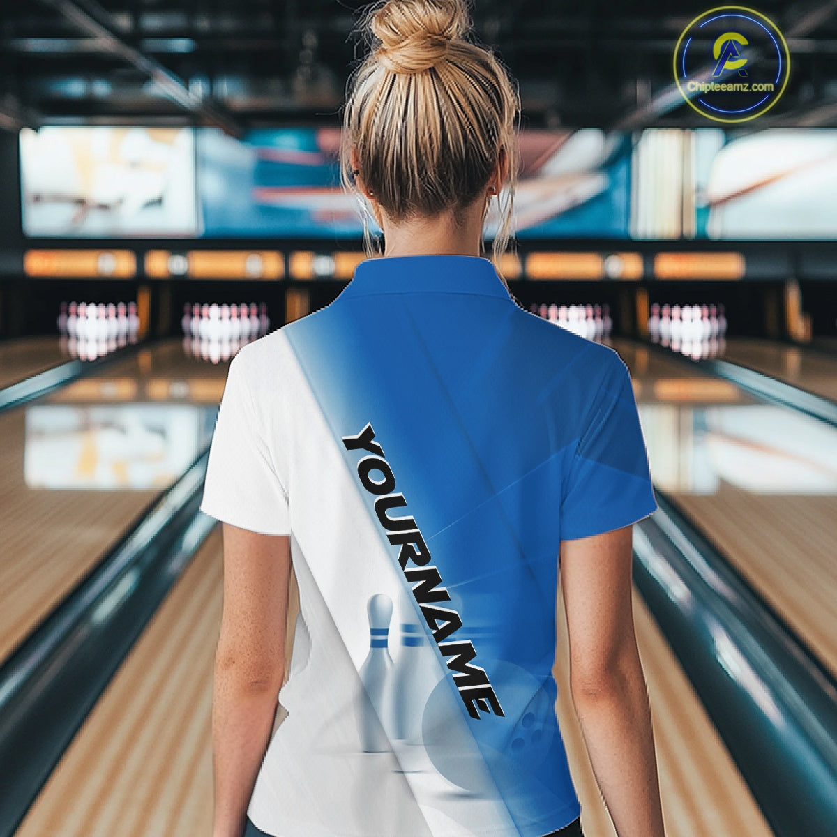 Back view of a female model at the bowling lane wearing a polo shirt with bowling ball and pins across a blue and white diagonal layout.