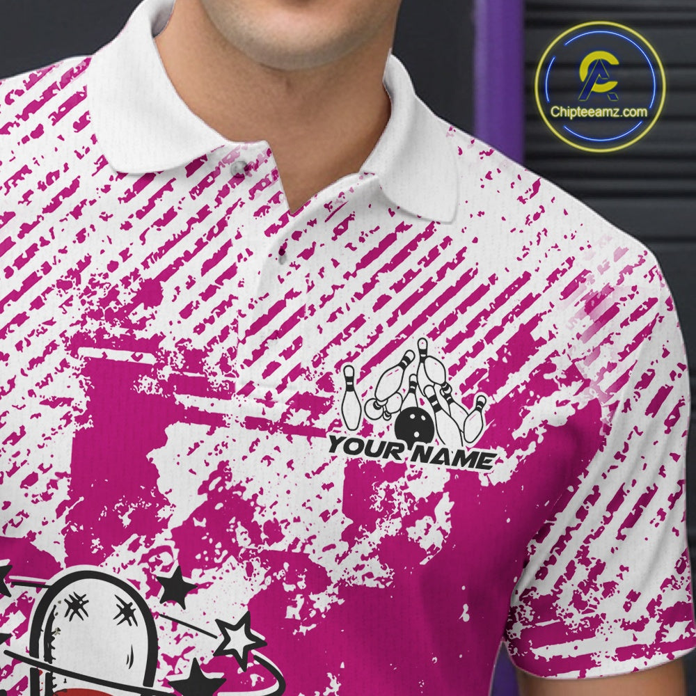 Close-up view of left chest area of a pink and white polo shirt, showing small detailed drunk bowling pin graphic with beer bottle and bowling ball.