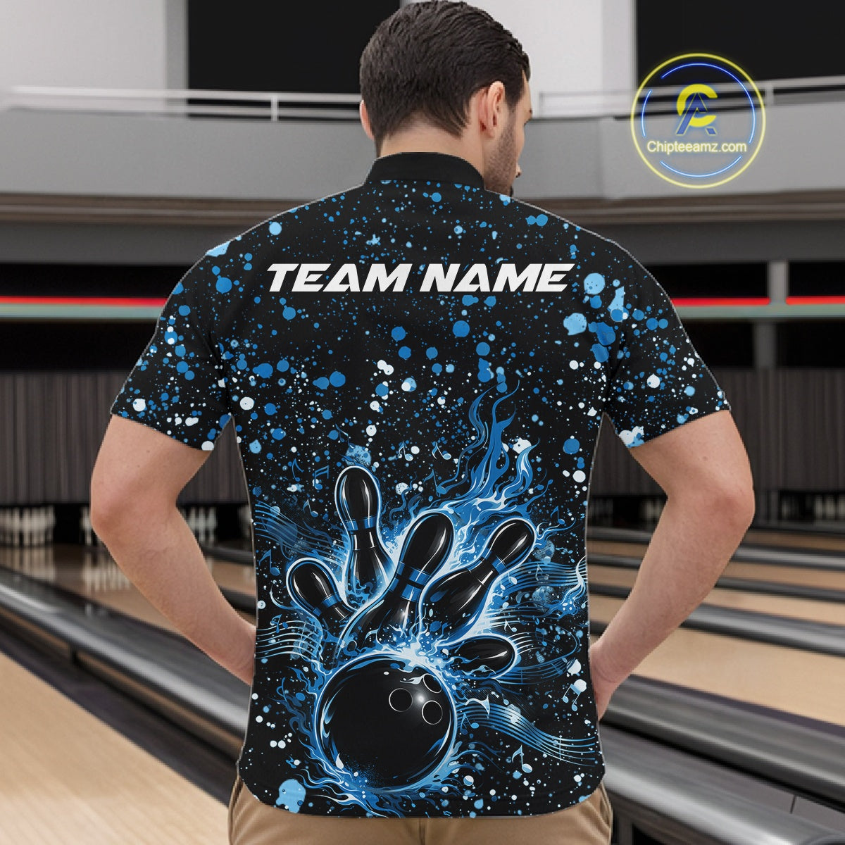 Front view of a male model in a black bowling quarter-zip shirt featuring blue paint splatter bowling strike graphics.