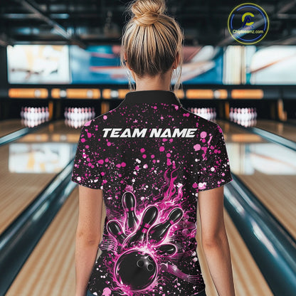 Back view of a female model in a black bowling quarter-zip shirt showcasing flaming bowling artwork and pink paint accents.