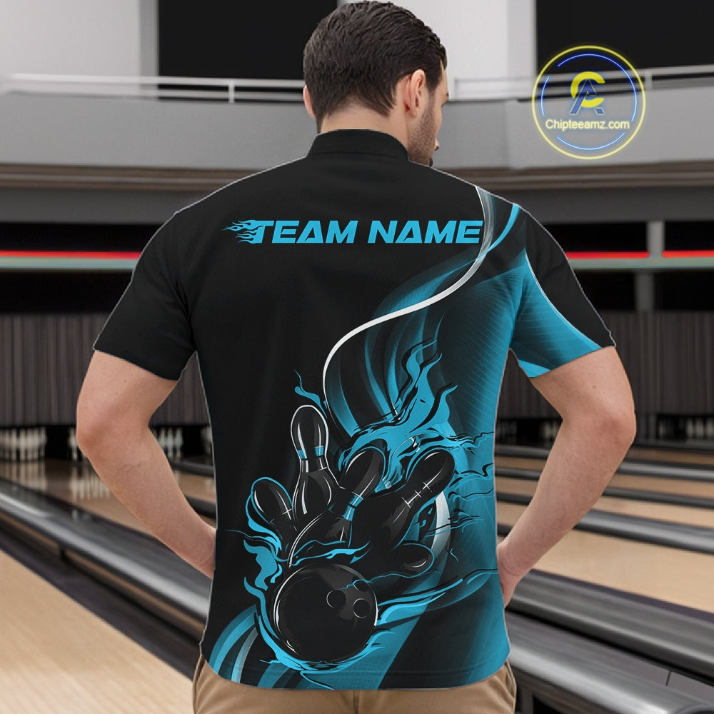 Male model front view inside bowling center wearing black and blue quarter zip shirt showcasing flaming bowling strike graphics