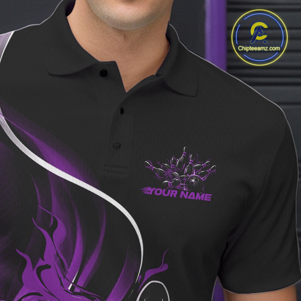 Close-up view of the left chest area of a black and purple bowling polo shirt showing a flame bowling ball and pins design detail.