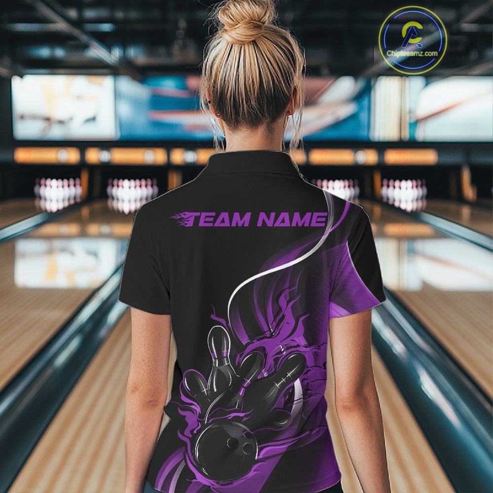 Back view female model at bowling lane wearing black and purple quarter zip shirt featuring flame bowling ball hitting pins artwork