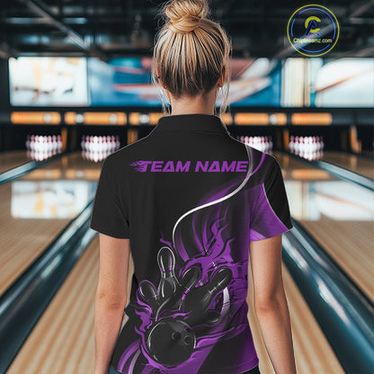 Back view female model at bowling lane wearing black and purple quarter zip shirt featuring flame bowling ball hitting pins artwork