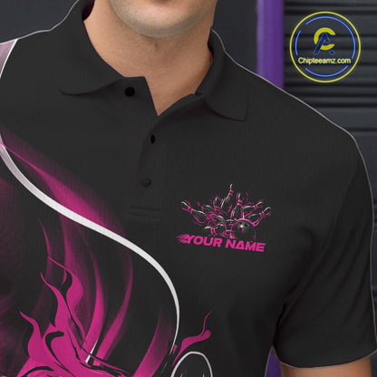 Close-up view of the left chest area of a black and pink bowling polo shirt showing a flame bowling ball and pins design detail.