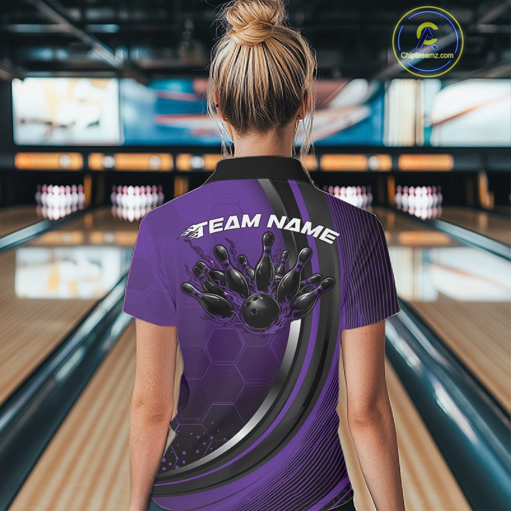 Back view of a black and purple women s bowling quarter zip displaying honeycomb details and flaming bowling strike artwork inside a bowling venue.
